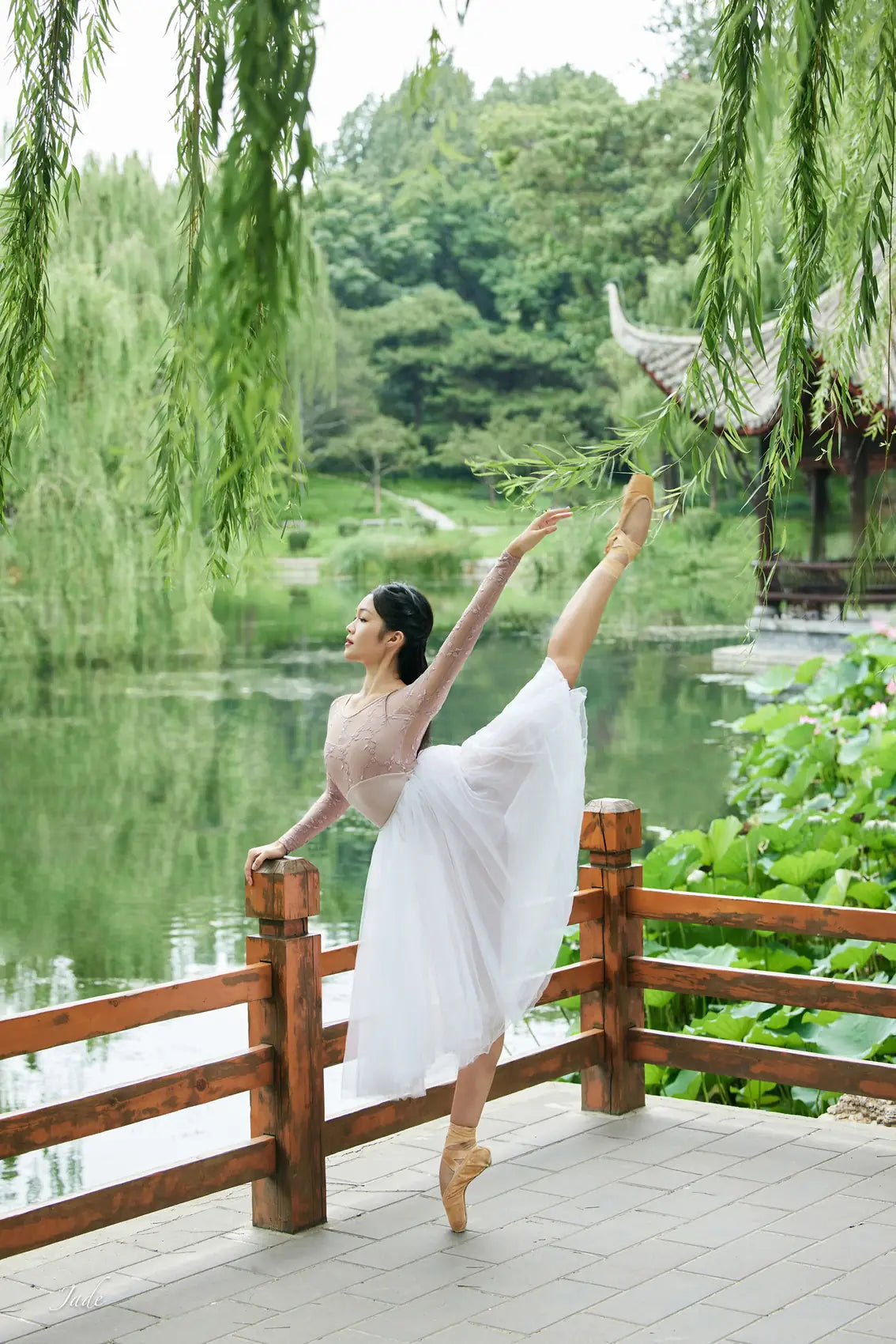Dancer on pointe in a garden setting.